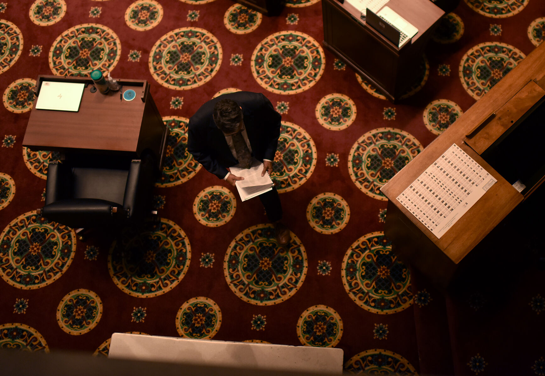 A man leaves the chamber at the end of a hearing
